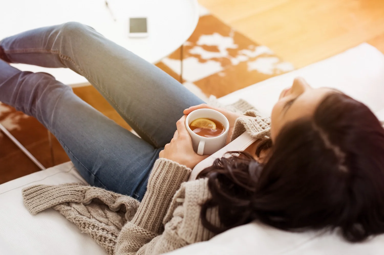 a woman relaxes on the sofa